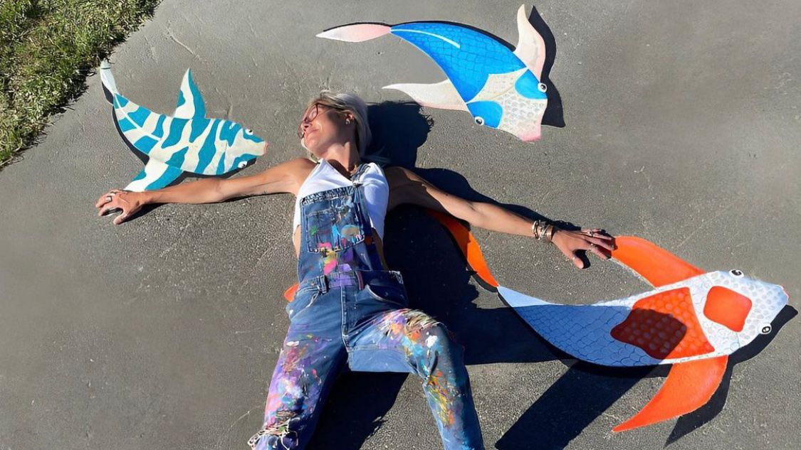 Sally Martin poses with Freeno, Flounder and Floyd, the fish she painted at Echo Farms Park. (Courtesy: Sally Martin)